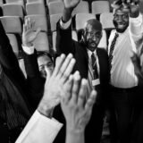 photo of professionals raising their hands related to black history month